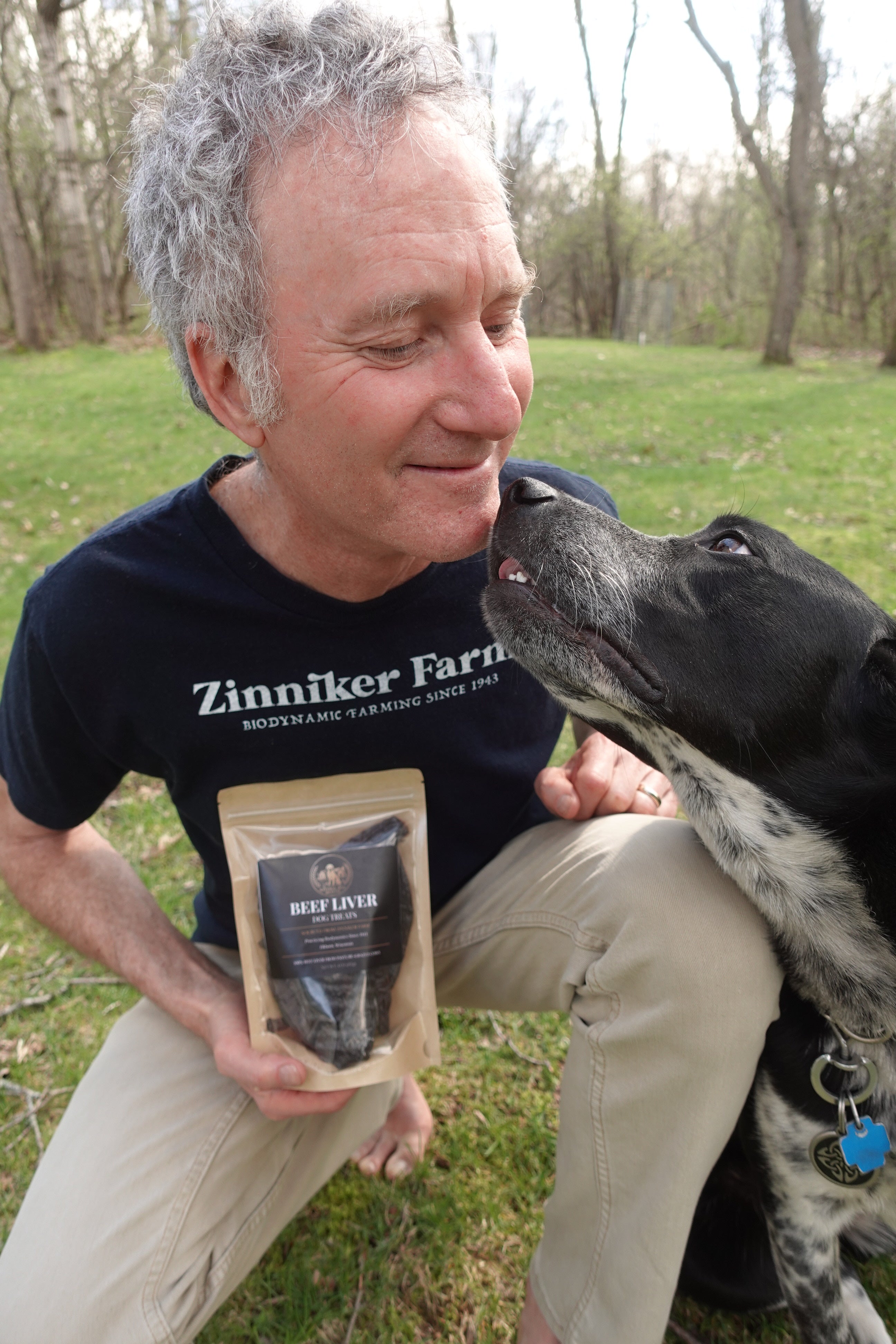 Chuck Ginsberg with his dog Winnie, holding a bag of Beef Liver Dog Treats
